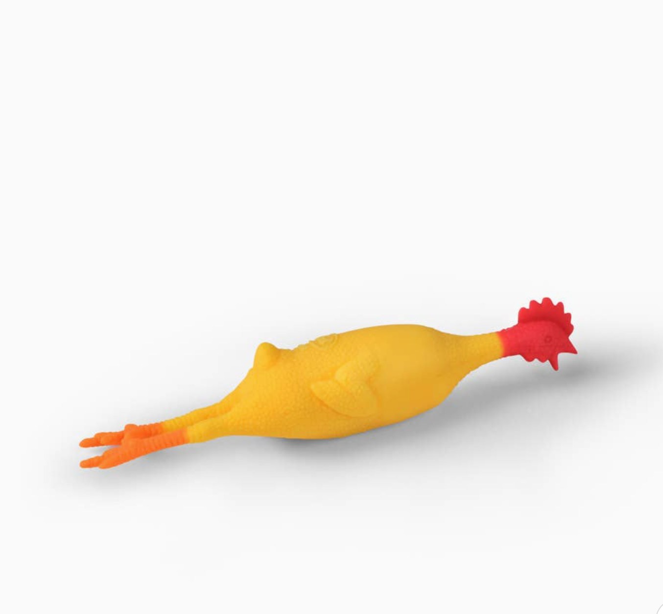 A yellow rubber chicken toy with orange feet and a red comb, shown lying on its side against a plain white background.