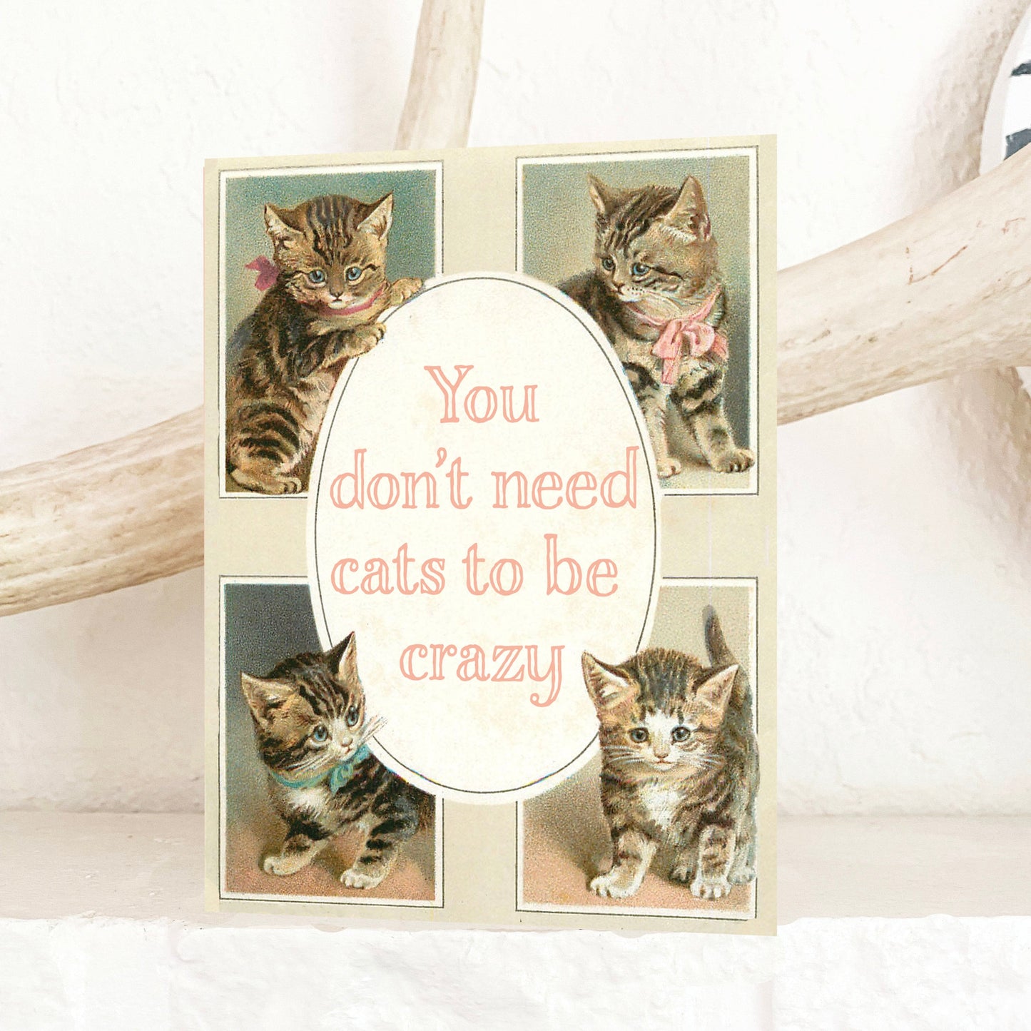 Vintage-style card with four illustrations of cats and a humorous quote “You don’t need cats to be crazy” on a white background.