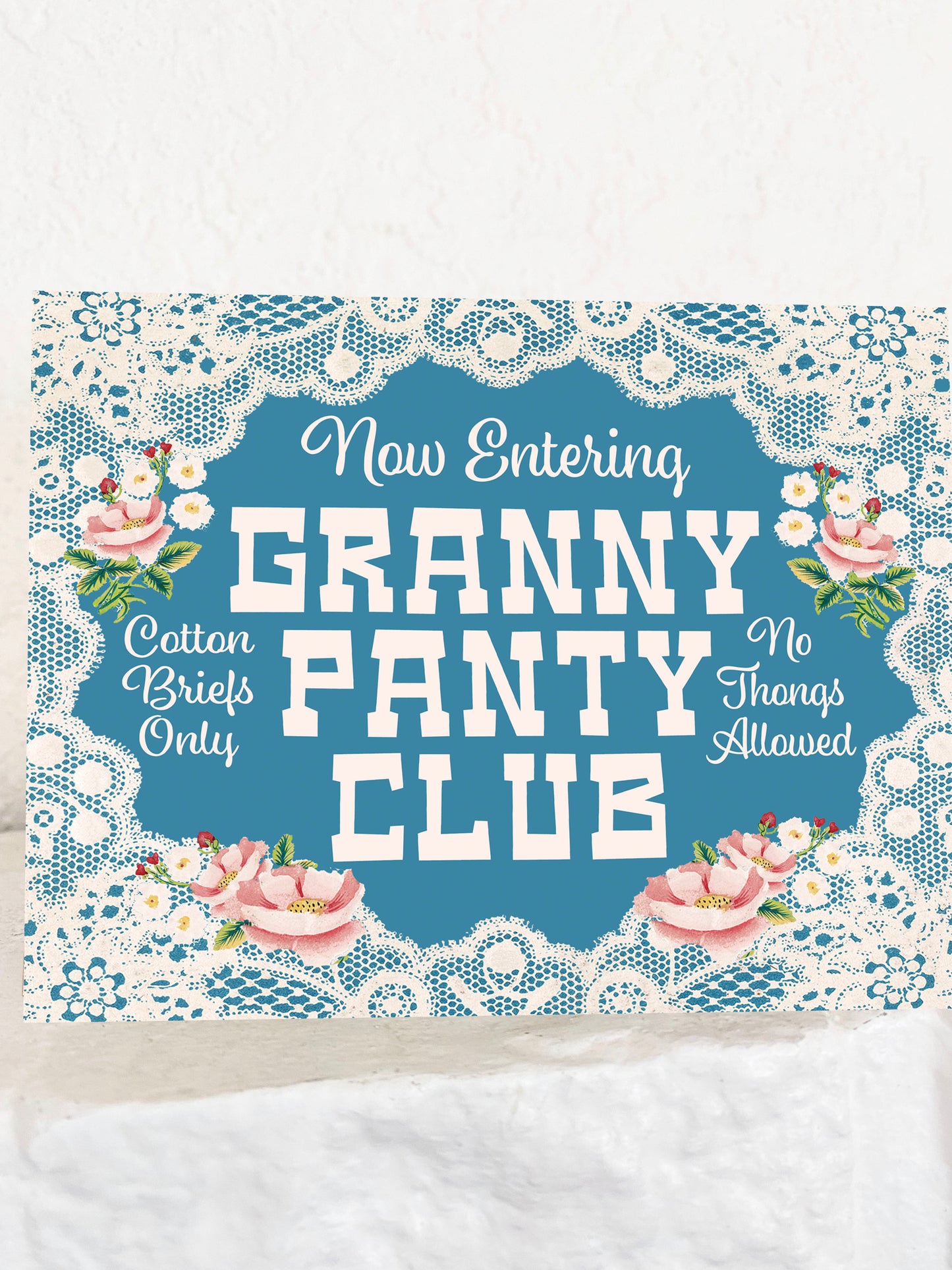 Card with 'Granny Panty Club' with floral and lace design elements.