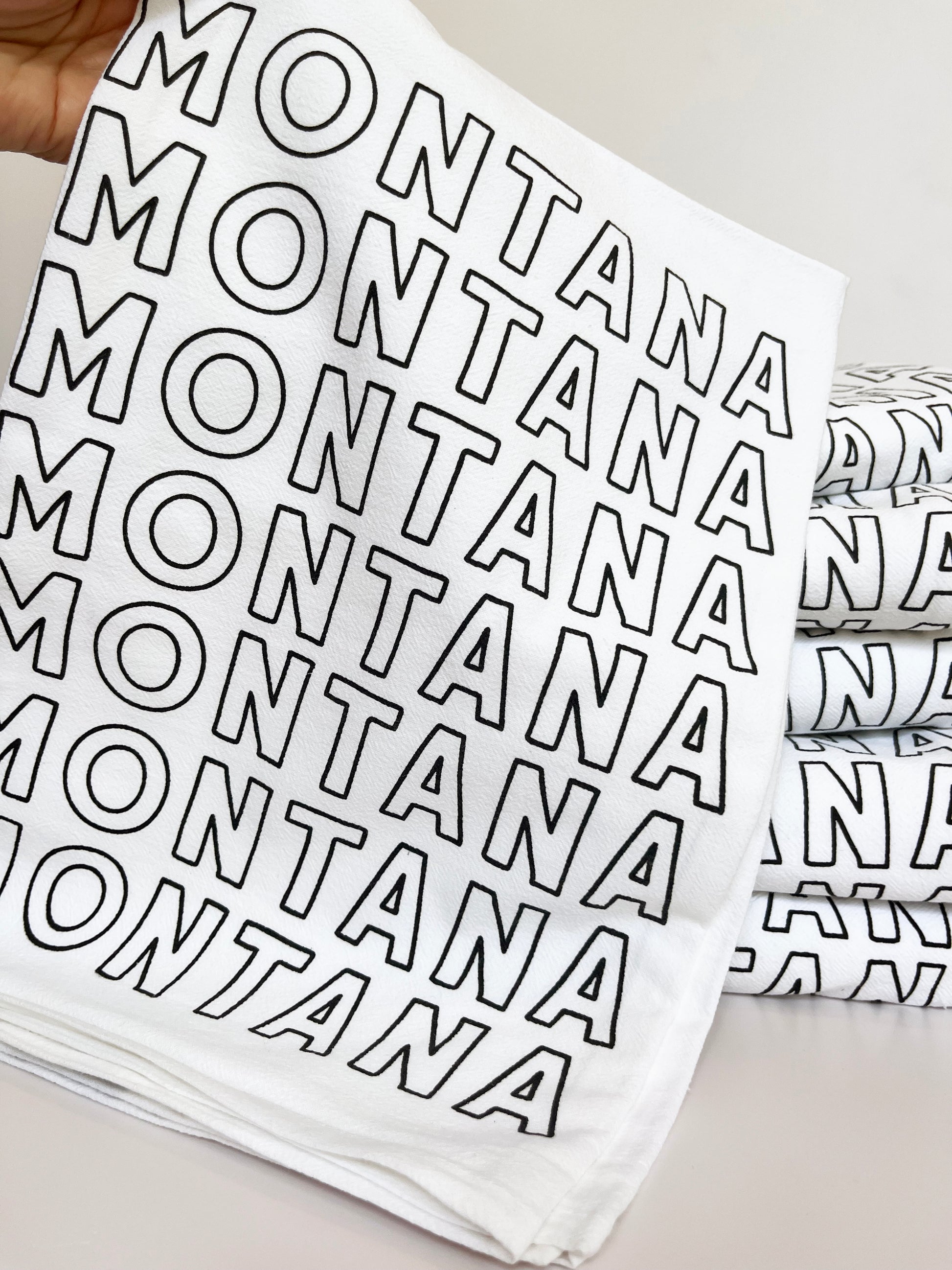 montana typography screen printed cotton kitchen towel montana written in outlined letters montana souvenir big sky bozeman missoula helena billings yellowstone glacier national park coin laundry fun cotton screen printed tea towels