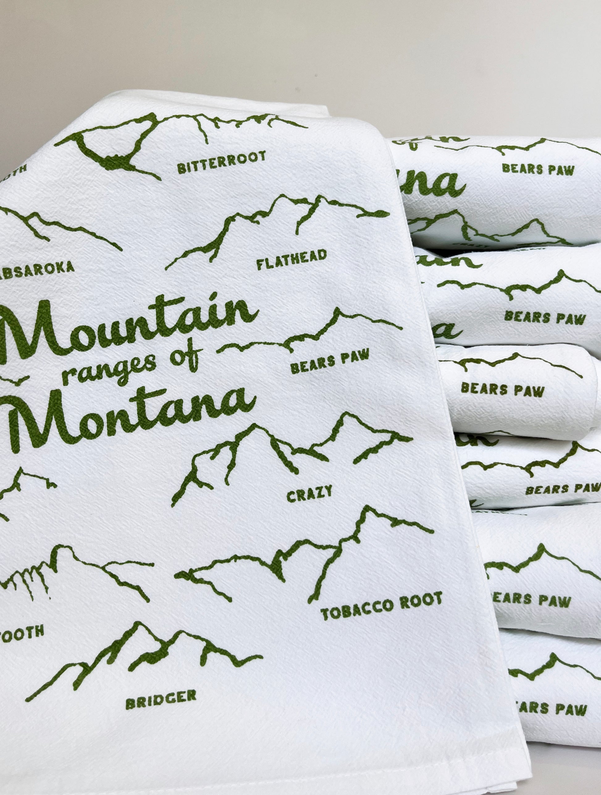 cute cotton kitchen dish towel with drawings of mountain ranges in montana green screen print montana yellowstone glacier bozeman missoula big sky souvenir coin laundry