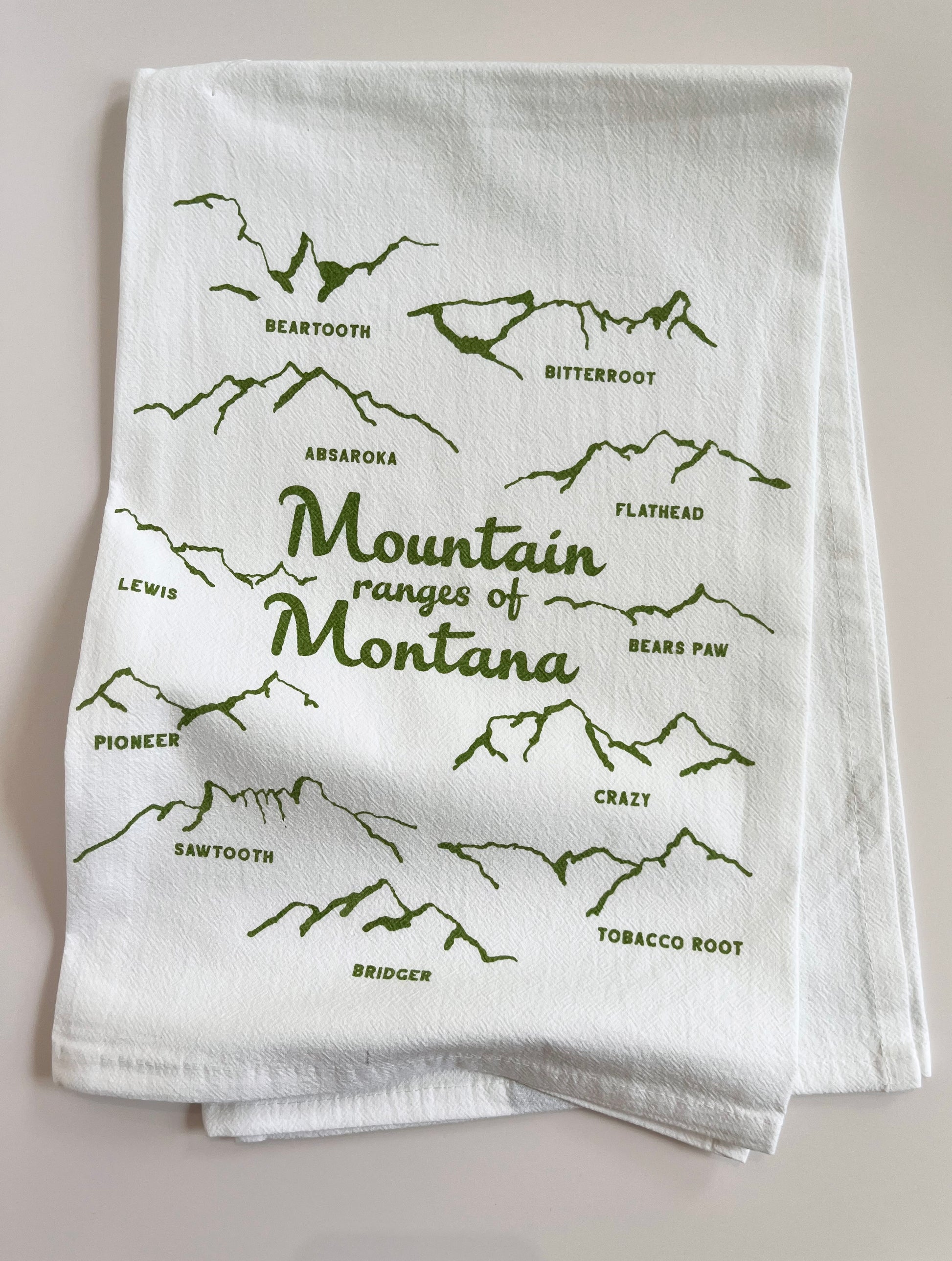 coin laundry screen printed tea towel mountain ranges of montana hand drawn illustration of mountain ranges fun montana gift housewarming wedding gift for visitors cute fun home decor for travelers