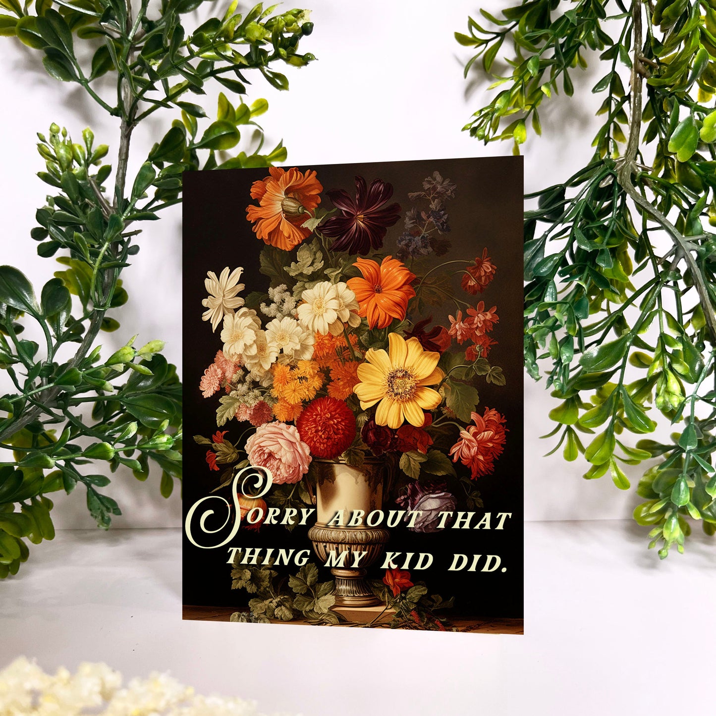 Floral arrangement card with sorry about that thing my kid did text on a decorative background