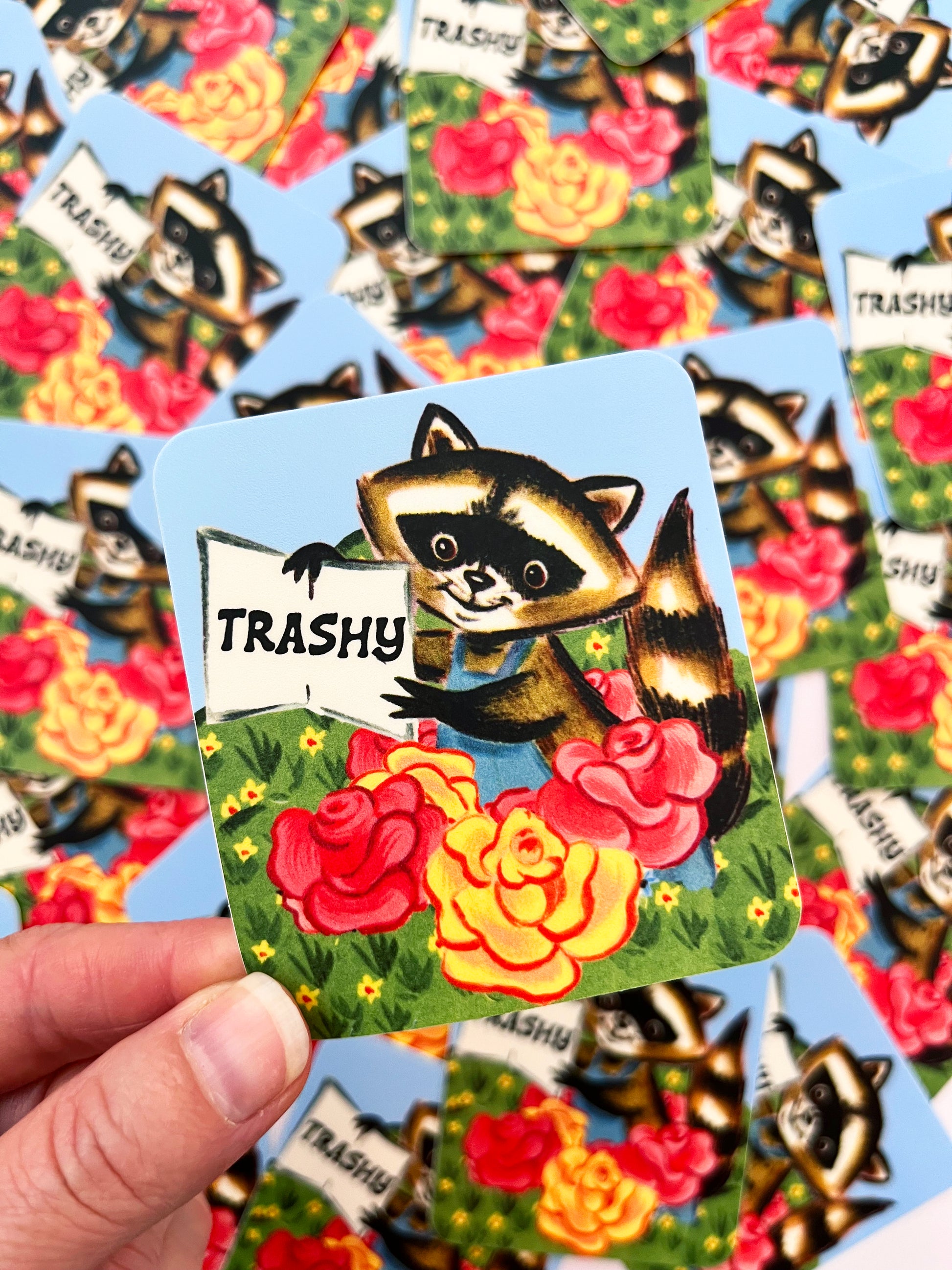 cute trashy raccoon sticker flowers pink yellow raccoon wearing overalls sticker fun stickers coin laundry montana