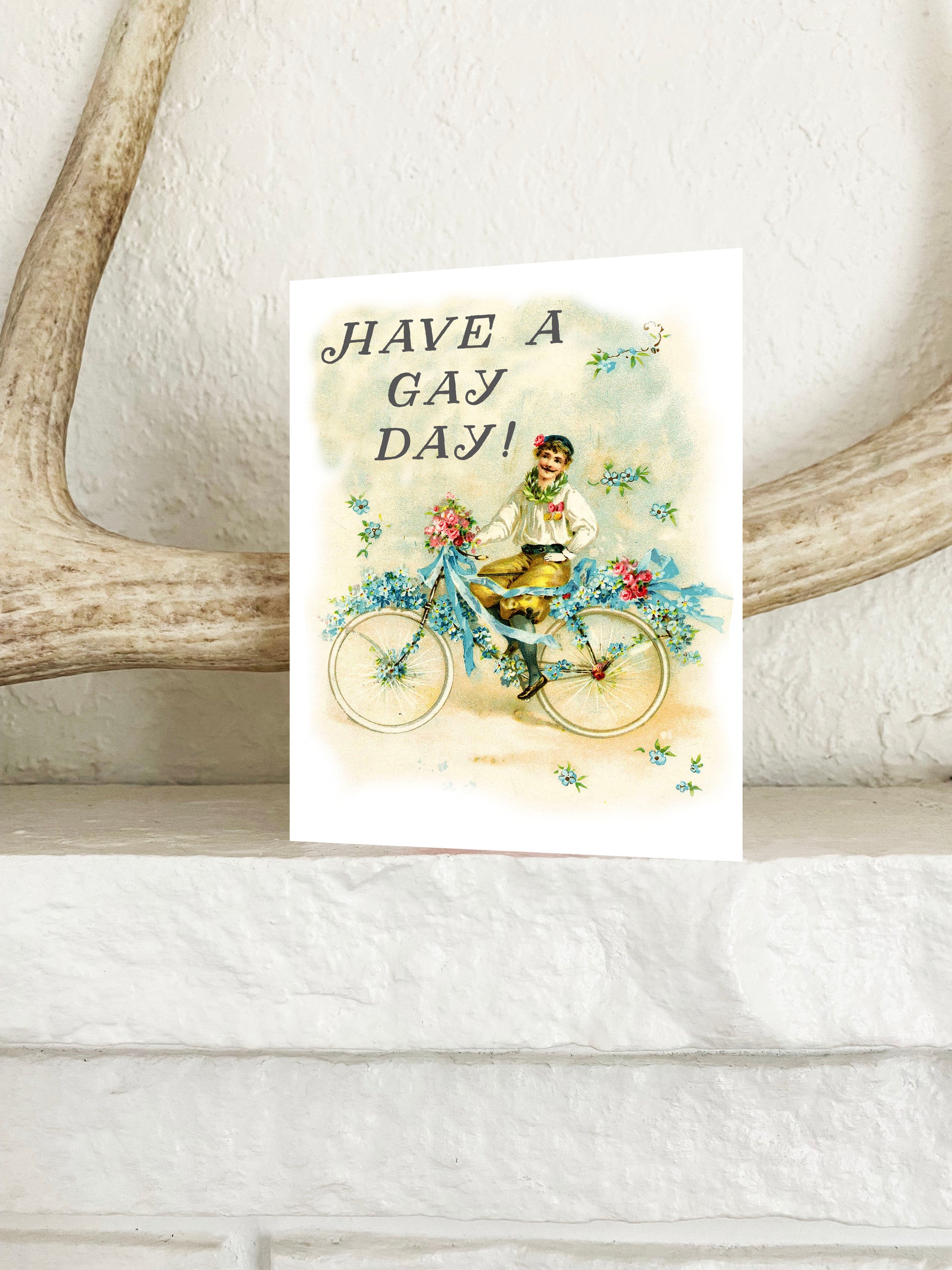 pretty cute fun greeting notecard note card retro vintage style man on bicycle pastel colors says have a gay day on the front blank inside send to best friend crush girlfriend boyfriend partner lgbtq neighbor sister brother coworker coin laundry