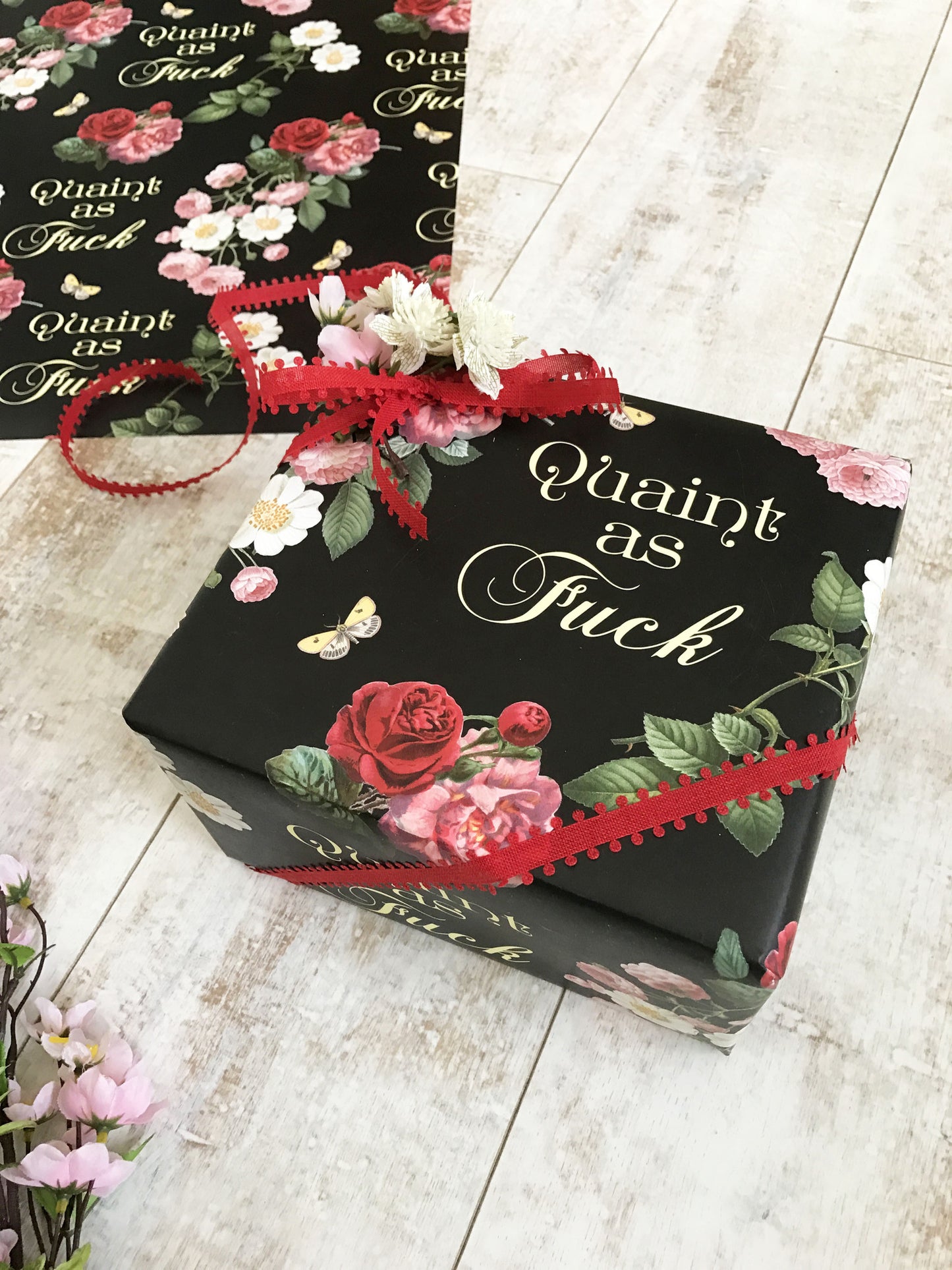 cute pretty wrapping paper dark vibrant colors black background with floral design quaint as fuck af written in yellow cursive all purpose gift birthday housewarming coin laundry