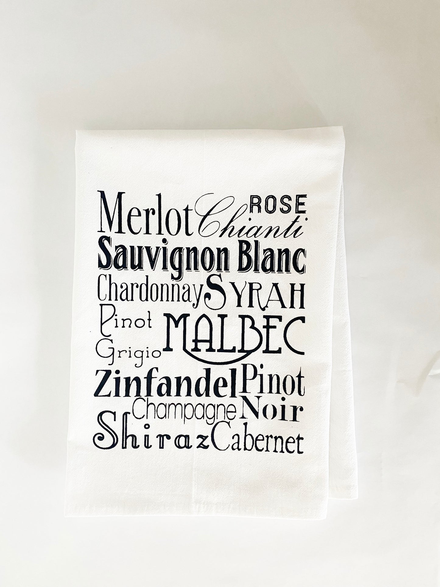 decorative kitchen towel with red and white wine varietals written in black and white type screen print coin laundry montana screen printed kitchen dish tea towel