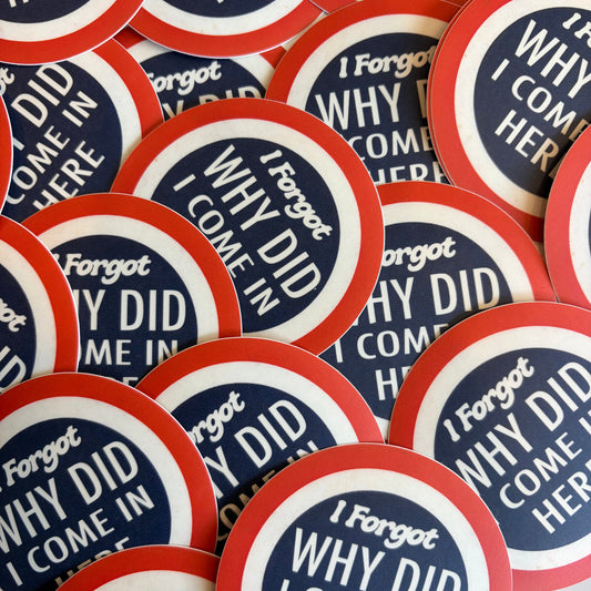 A pile of round stickers with a red, white, and navy blue design. The sticker features the text 'I Forgot WHY DID I COME IN HERE' in white lettering.