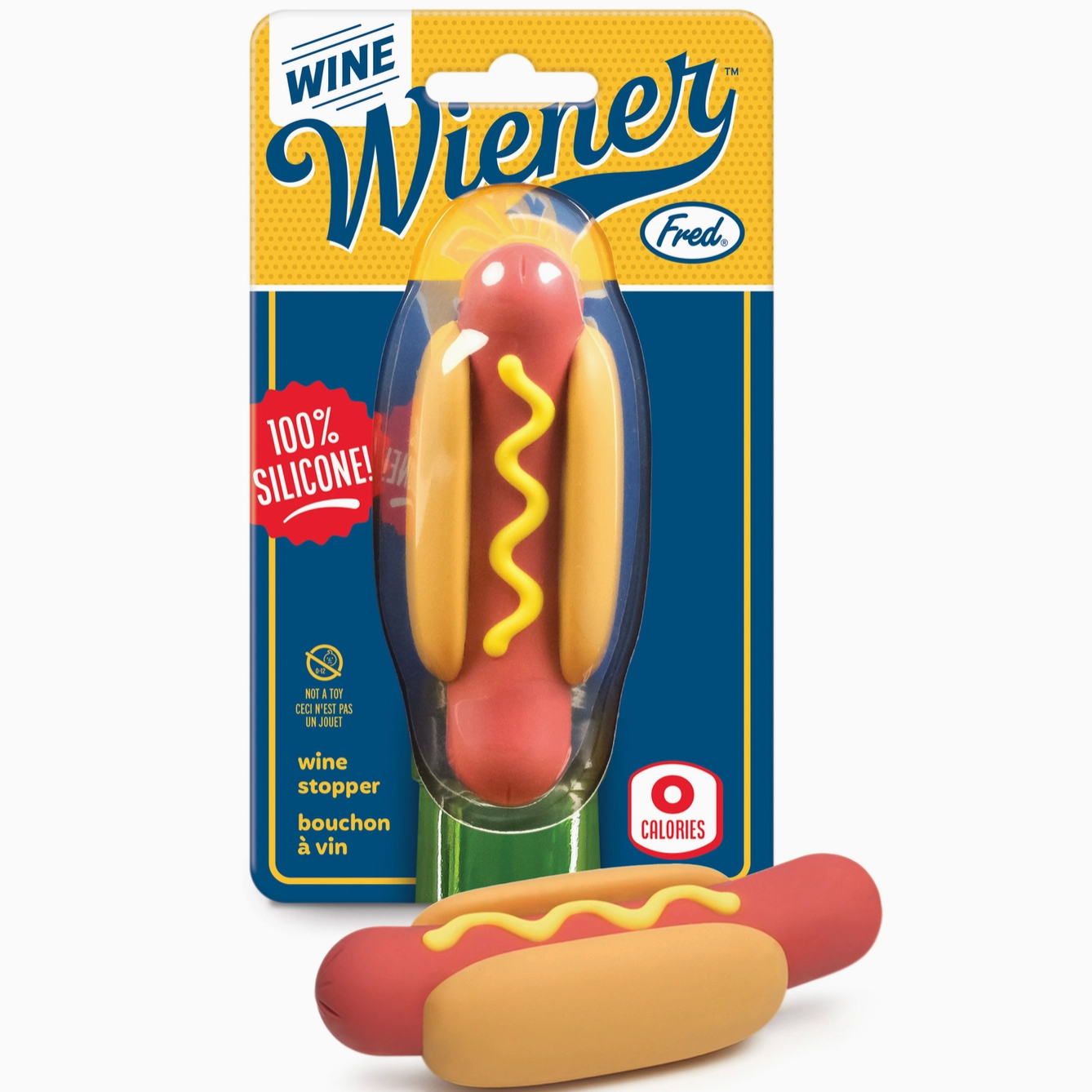A novelty wine stopper shaped like a hot dog in a bread bun, shown both inside its retail blister packaging and unpackaged in front on a light gray background. The package features a yellow and blue design with the brand name 'Fred.
