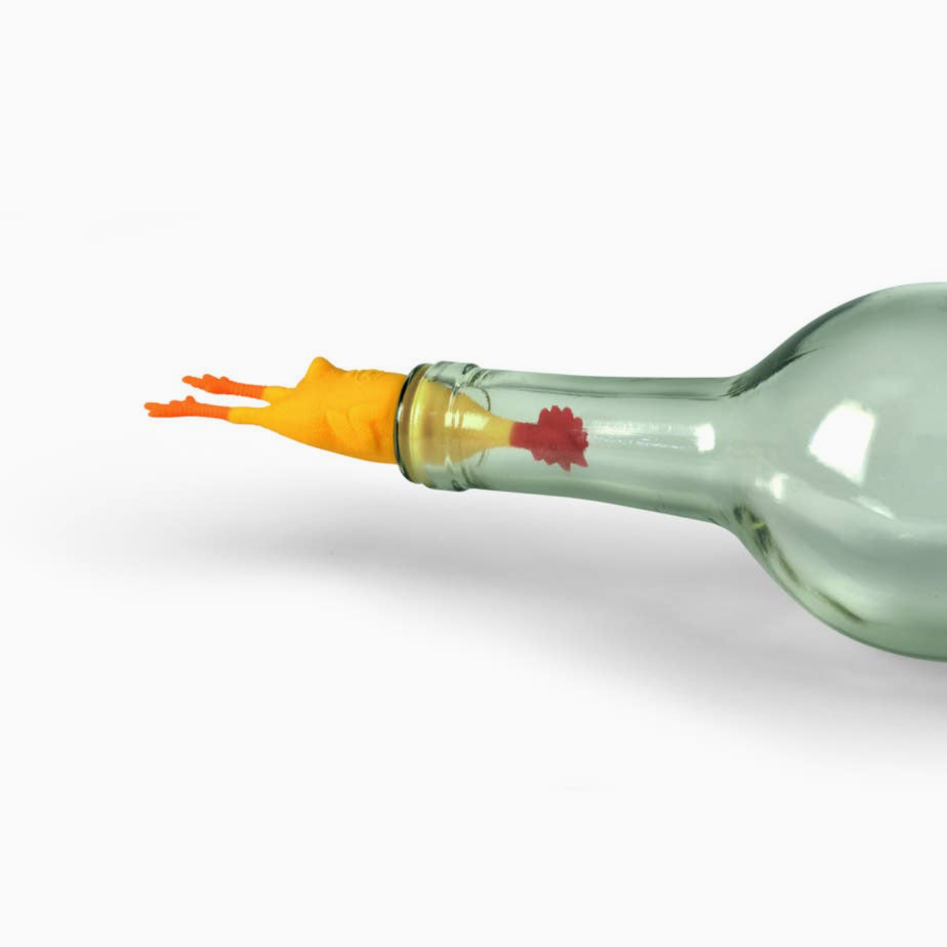 A clear glass bottle with a bright orange silicone stopper shaped like a small bird, featuring a small red graphic detail, shown against a plain white background.