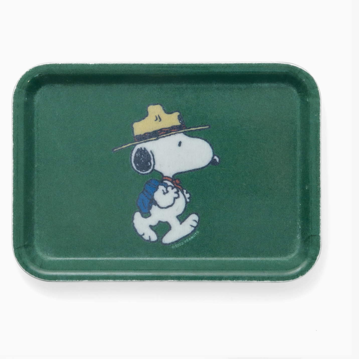 A green rectangular tray featuring a printed illustration of Snoopy wearing a yellow hat and blue backpack, shown on a plain white background.