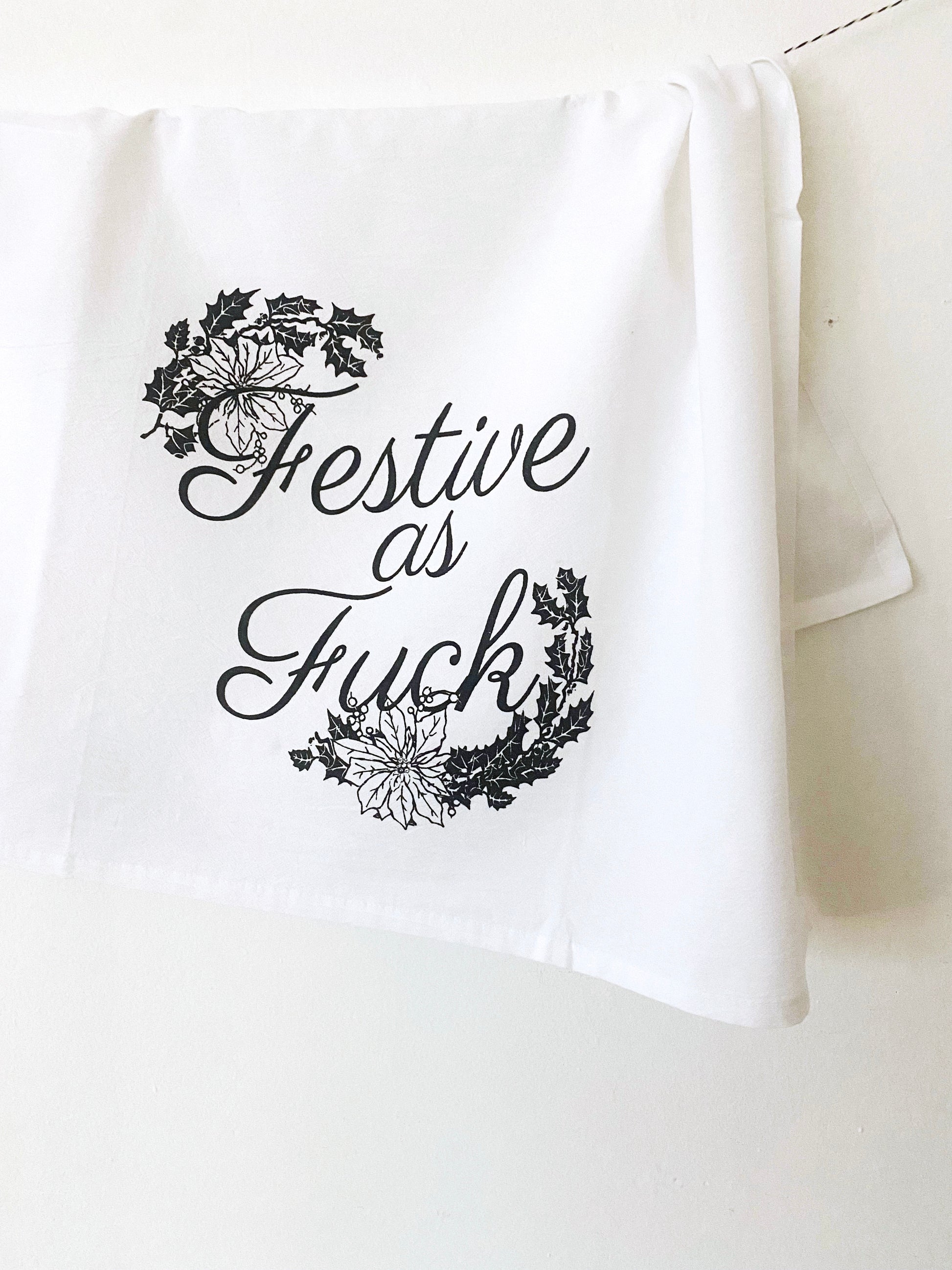 festive as fuck funny kitchen towel with retro vintage style kitsch kitschmas cute christmas decor funny holiday home gift for host poinsettia flowers cute coin laundry print shop montana
