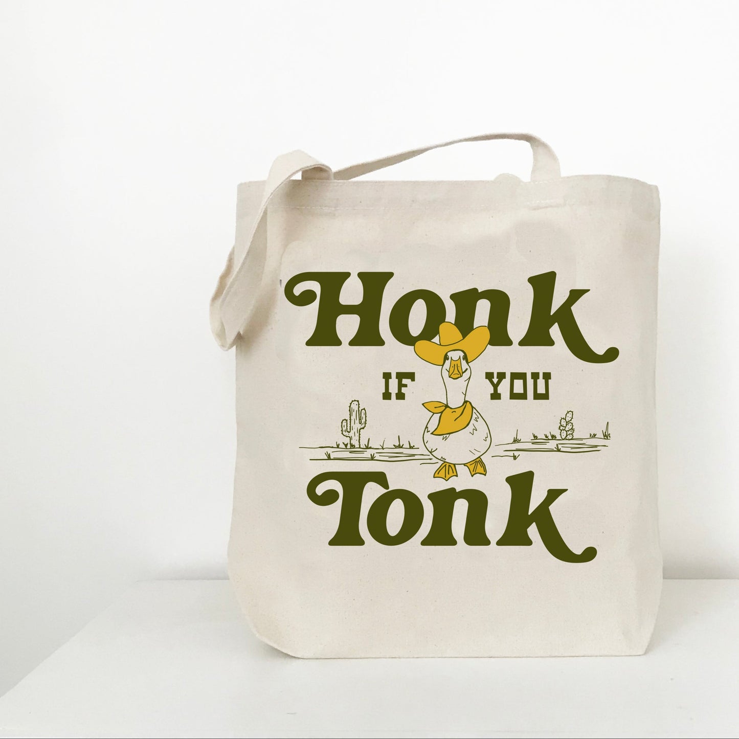 Tote bag with 'Honk if you Tonk' text and duck graphic on a white background