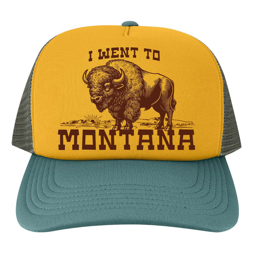 Yellow and forest green trucker hat with a bison graphic and text I went to montana on a white background
