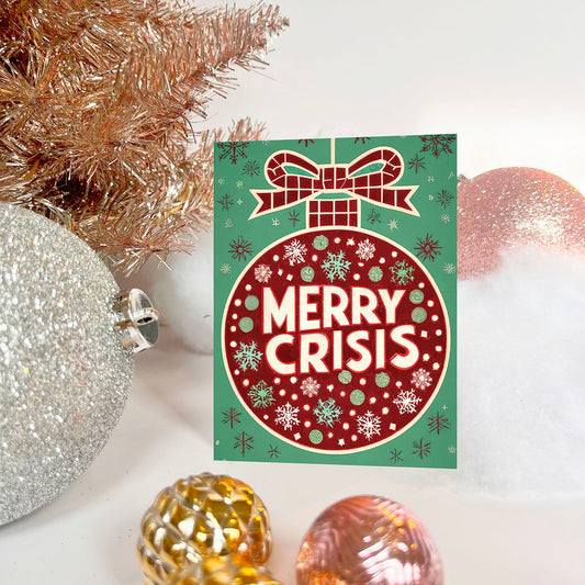 Red ornament on a green background with “Merry Crisis” text and snowflakes.