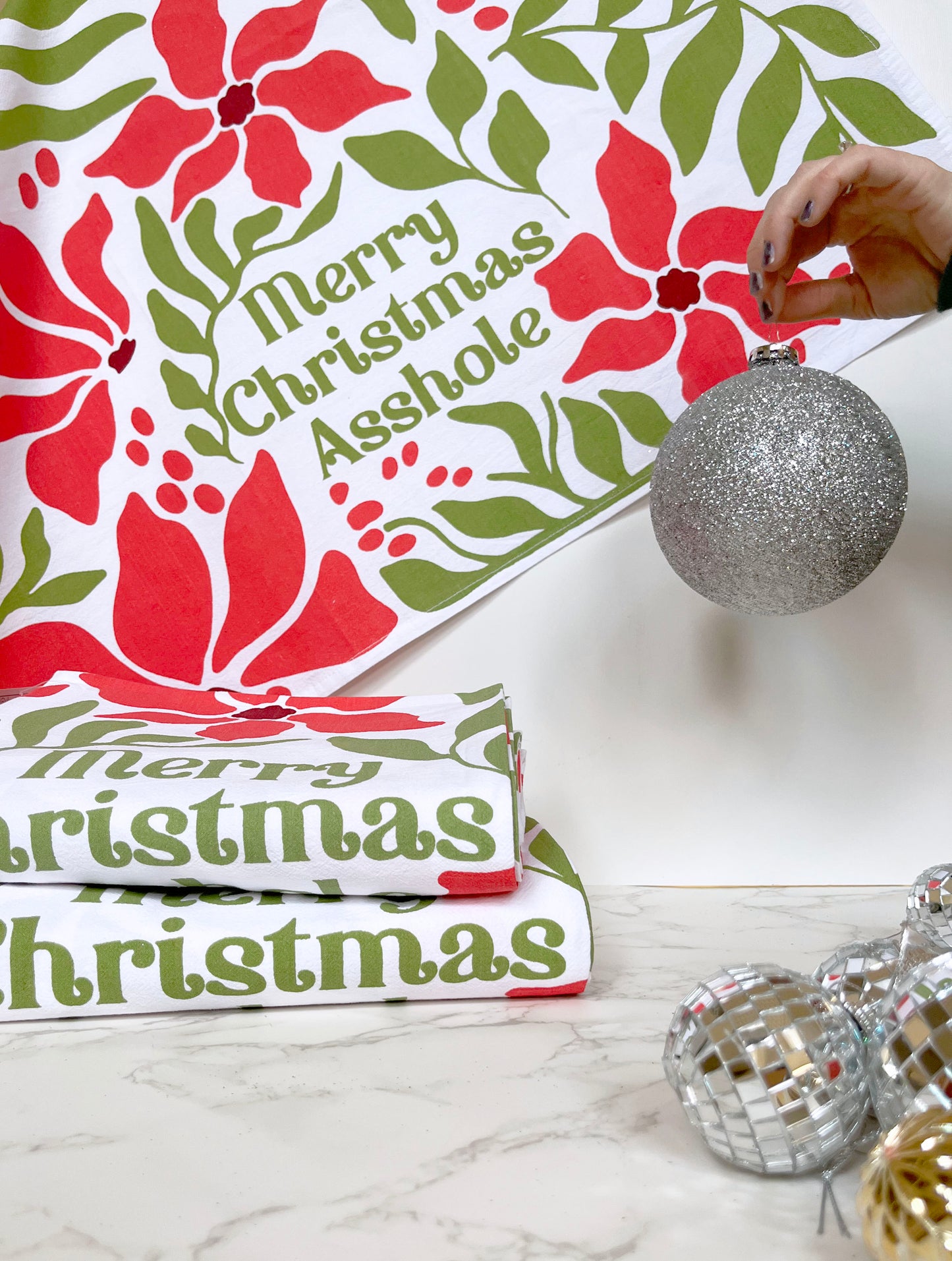Merry Christmas Asshole towel with a festive background