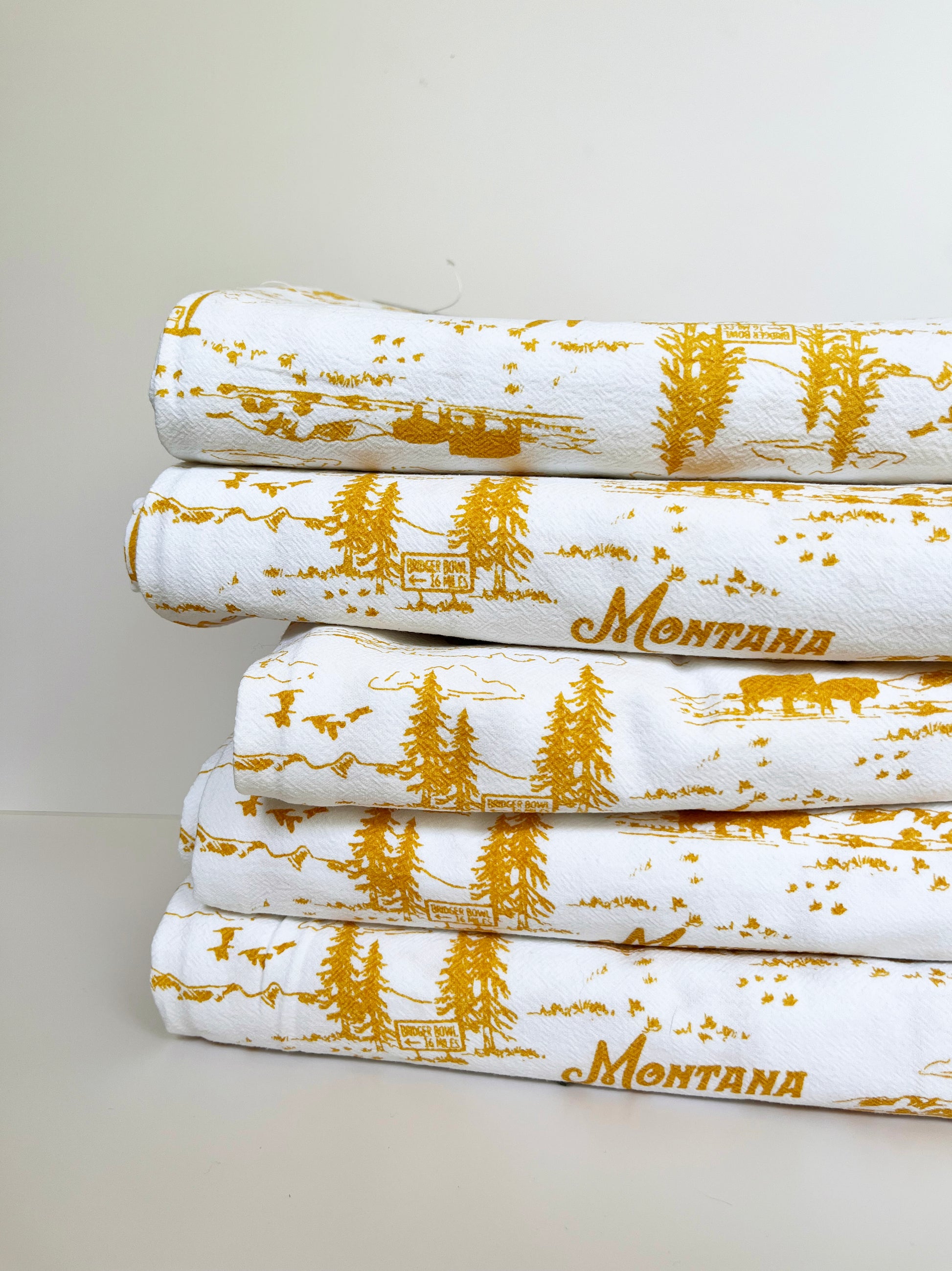 coin laundry montana kitchen towel hand screen printed print with cowboy western motif mountains trees yellow ochre yellowstone national park souvenir dish towel tea towel cotton retro style