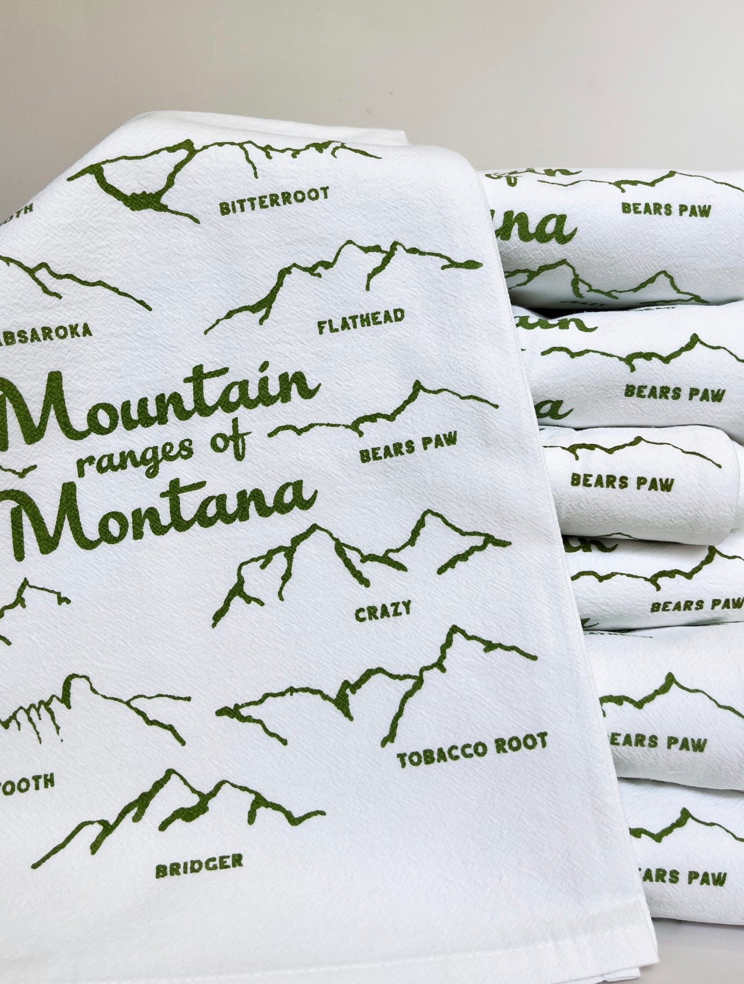 cute cotton kitchen dish towel with drawings of mountain ranges in montana green screen print montana yellowstone glacier bozeman missoula big sky souvenir coin laundry 