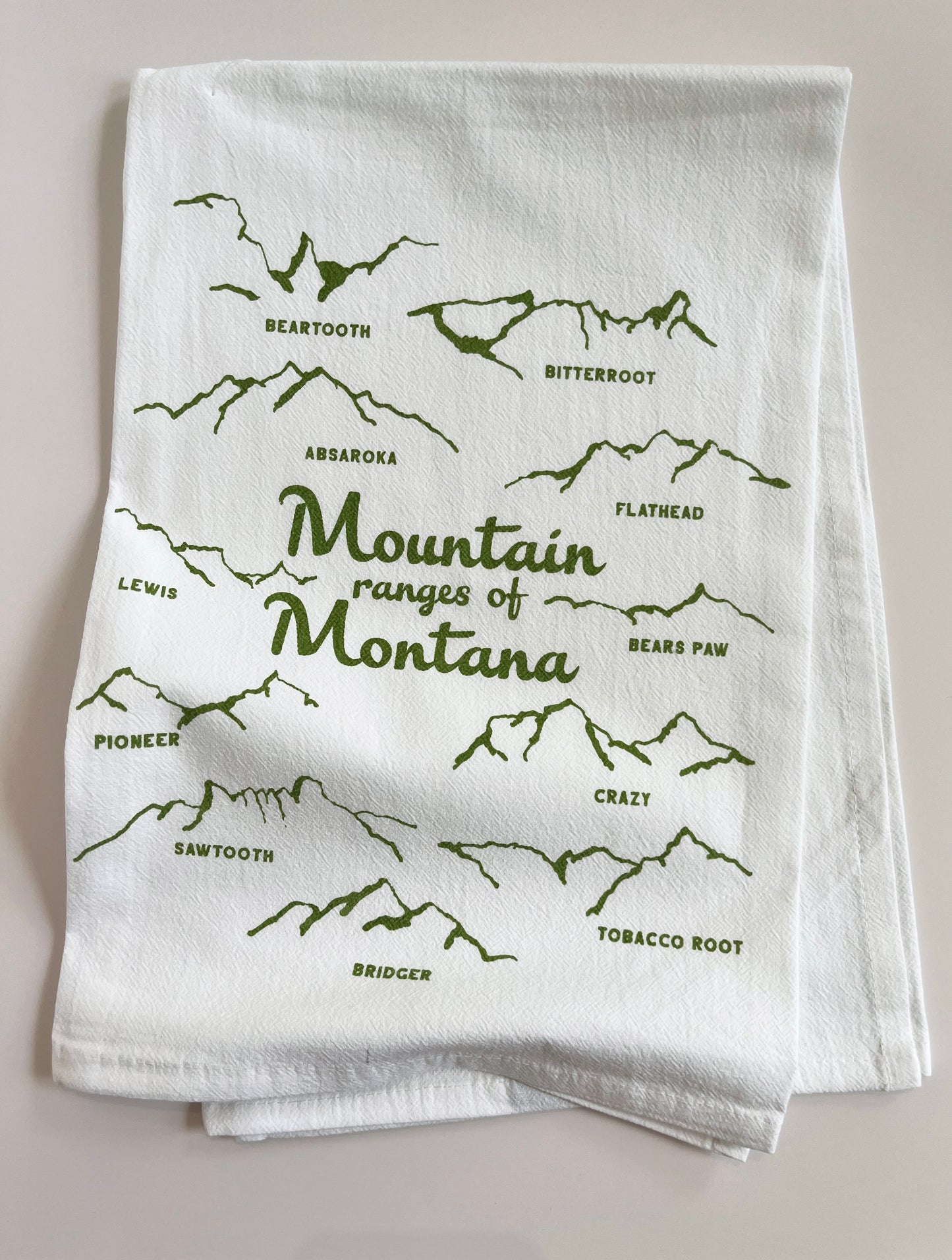 coin laundry screen printed tea towel mountain ranges of montana hand drawn illustration of mountain ranges fun montana gift housewarming wedding gift for visitors cute fun home decor for travelers 
