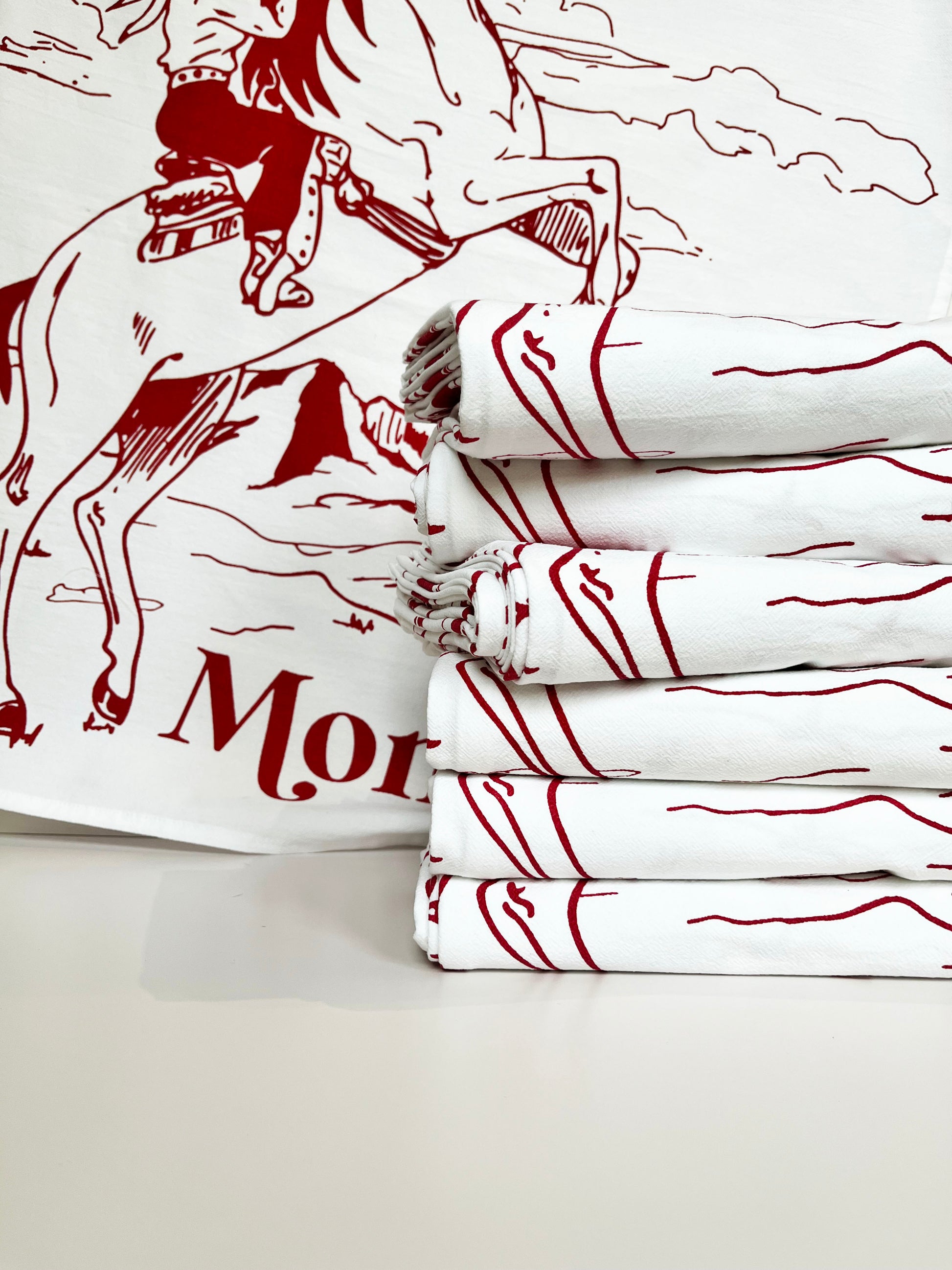 western cowgirl riding horse mountains sky screen printed illustration red ink all over design theres no place like montana modern cotton kitchen towels coin laundry montana 