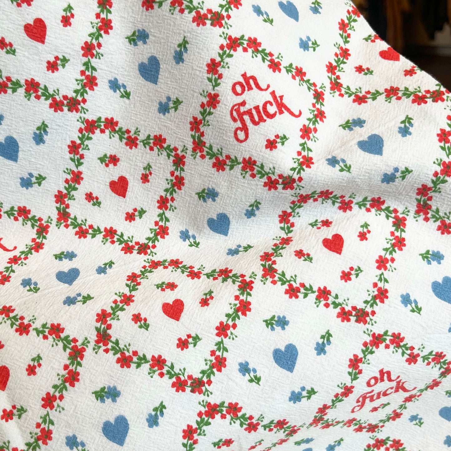 Floral patterned fabric with 'oh fuck' text