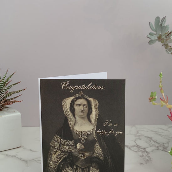 All purpose greeting card that says "Congratulations. I'm so happy for you." on the front. Color is shades of black and cream. Features a vintage image of a woman, extravagantly dressed, with a vacant stare. coin laundry  