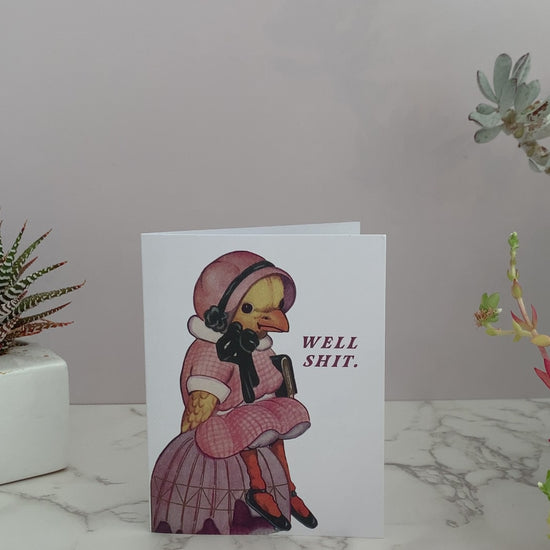 Greeting card that says, Well Shit on the front. Featuring a vintage duck dressed in a pink dress with a bonnet, slumped over sitting down. Great all purpose greeting card to send to a friend for a birthday, or because they're going through some shit. Blank inside.