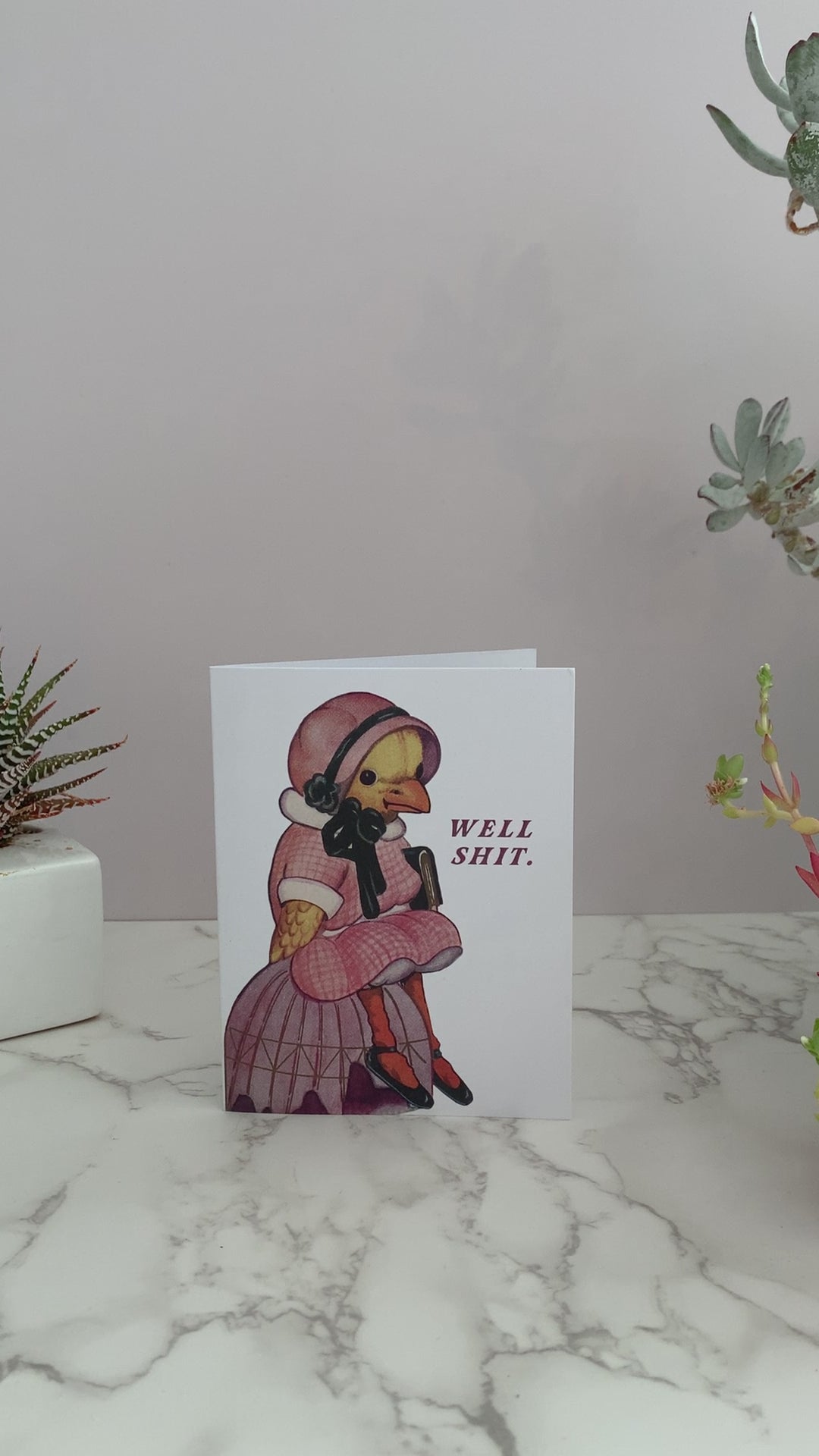 Greeting card that says, Well Shit on the front. Featuring a vintage duck dressed in a pink dress with a bonnet, slumped over sitting down. Great all purpose greeting card to send to a friend for a birthday, or because they're going through some shit. Blank inside.
