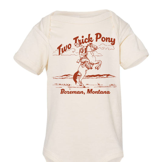 Baby onesie with 'Two Trick Pony' graphic  with cowgirl on a horse and text on a white background. Bozeman montana baby bodysuit