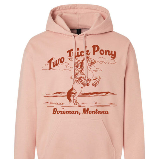 Pink hoodie with two trick pony graphic design with cowgirl and horse and bzoeman montana 