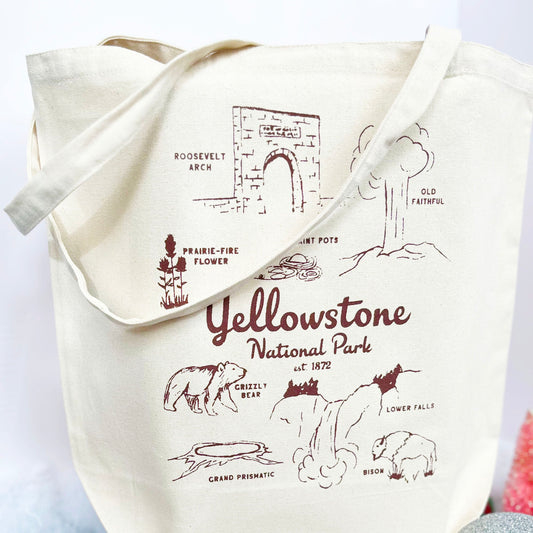 Tote bag with Yellowstone National Park illustrations and text on a white background