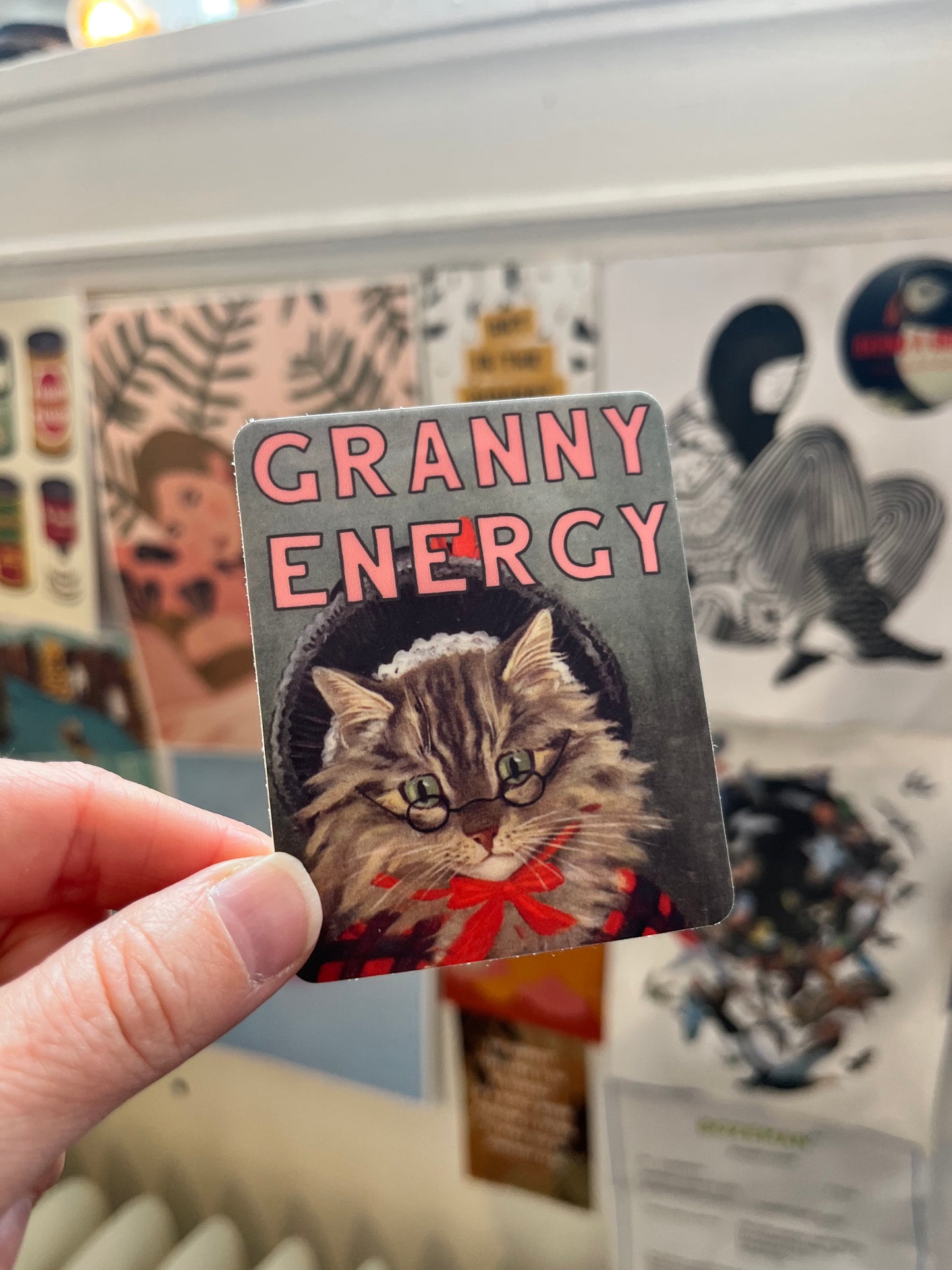 high quality vinyl sticker rectangle text granny energy with vintage cat wearing hat glasses bow sweater kitty tabby kitten grandma grandpa old lady sewing gardening cooking homesteading sustainable living canning pickling plants crafting home improvements coin laundry montana