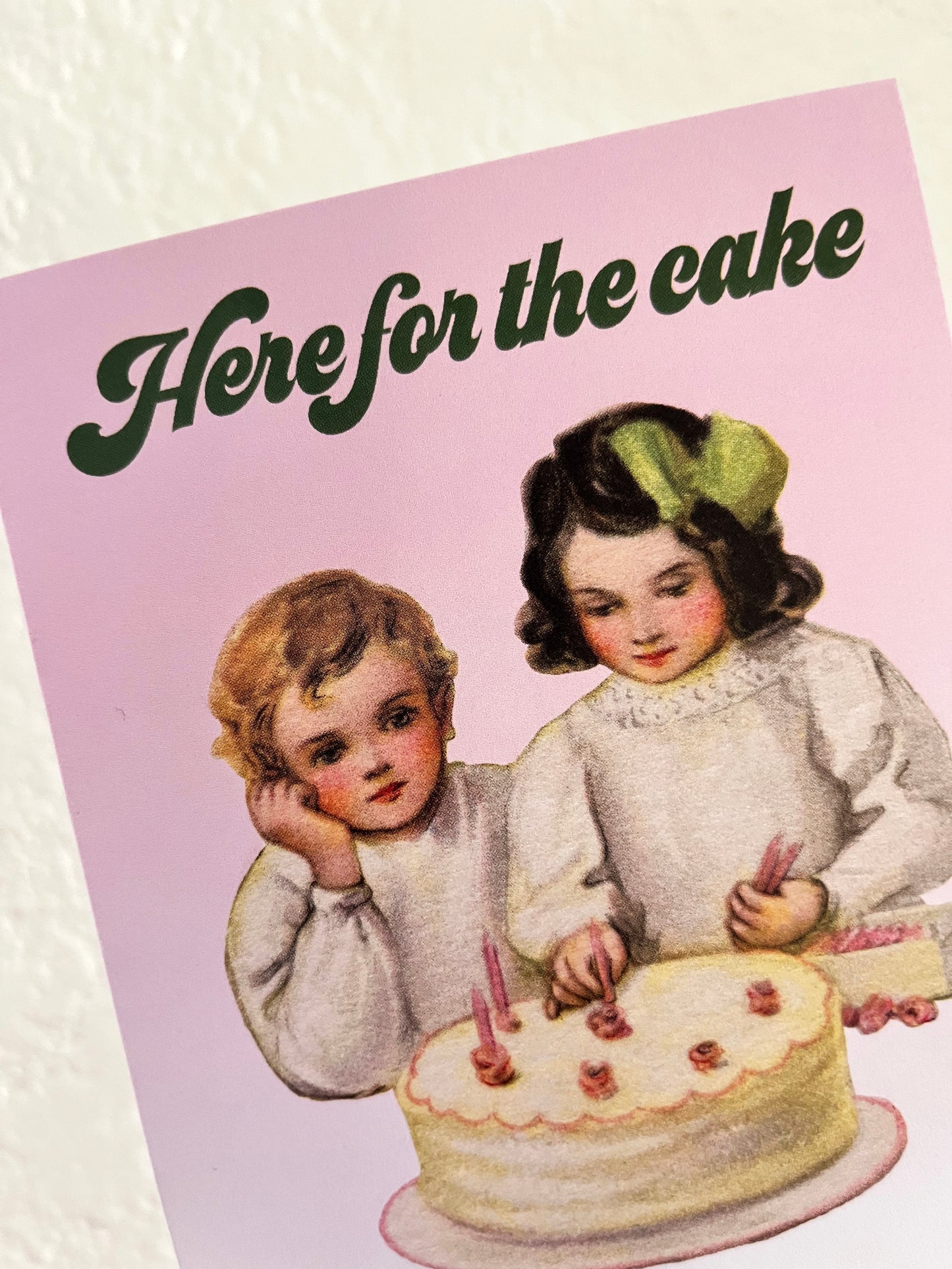 two kids boy and girl putting candles on white cake with pink candles pastel cute retro vintage style holiday birthday celebration card funny here for the cake