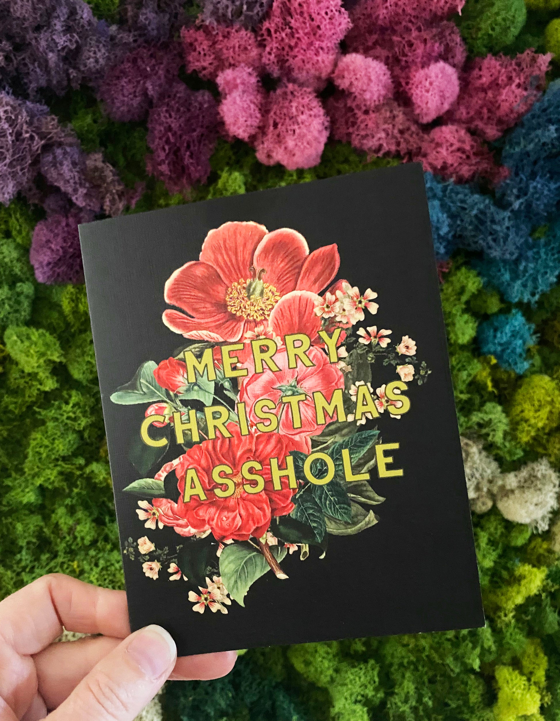 pretty vintage style christmas card with black background red white flowers front says merry christmas asshole snarky joke funny